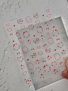 Autocollants nail art holographiques avec cœurs rouges, nœuds et lettrage Good Look