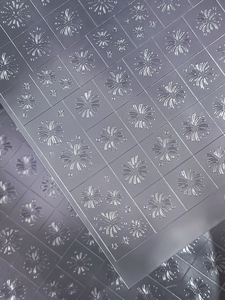 Macro shot of semi-transparent embossing folder with firework and star pattern textures