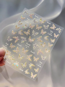 Macro view of butterfly nail art stickers with laser pearlescent finish and blue glow