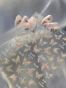 Detail of YT7143 iridescent butterfly embossed nail art stickers on a pink base