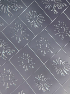 Macro view of textured plaid snowflake nail stickers with heart and firework patterns