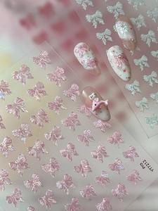 Detail of 3D embossed iridescent bow nail stickers with laser holographic texture