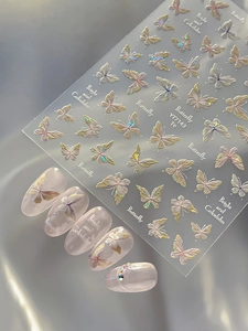 Detailed holographic 3D butterfly nail stickers showing realistic application on nails