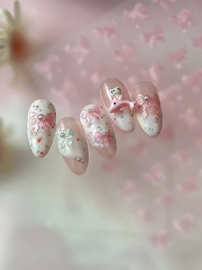 Detailed view of handmade pink bow press-on nails with 3D cartoon character and pearls