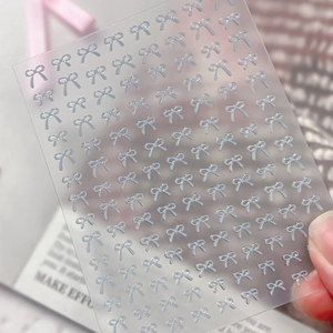 3D light blue ribbon bow nail art stickers with embossed relief texture on clear sheet