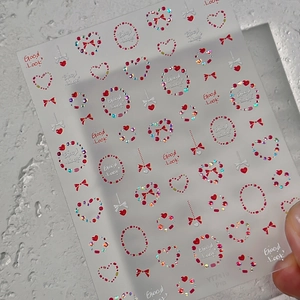 Stickers à ongles cœurs 3D avec strass rouges et irisés sur film transparent adhésif