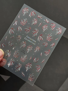 Dettagli macro di adesivi per unghie 3D con fuochi d'artificio rossi e glitter laser