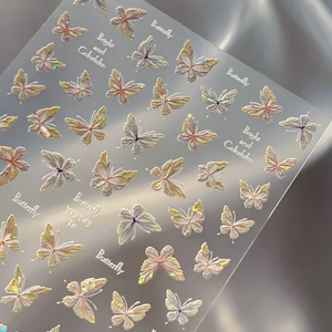 5D embossed butterfly nail stickers with aurora shimmer on grey satin background