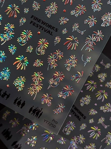 Detailed macro view of holographic fireworks nail stickers with embossed glitter texture