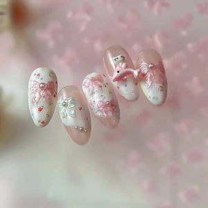 Pink and white 3D press-on nails featuring cute Hello Kitty bow and pearl decorations