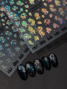 Detailed holographic fireworks nail stickers applied on black tips for festival nail art