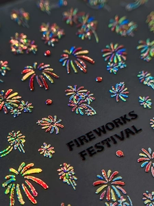 Macro shot of 3D embossed laser firework nail stickers with iridescent visual effects