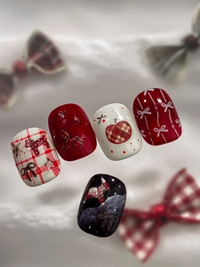 Detail of red and blue checkered nail art stickers with 3D pony and apple patterns