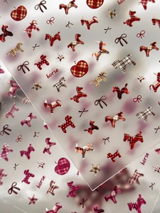 Detail of plaid nail art stickers featuring classic horse and bow-knot patterns