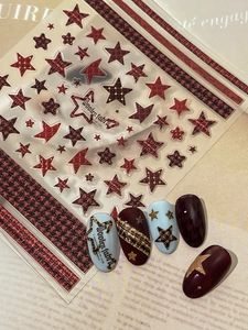 Macro shot of 5D embossed star and red houndstooth nail art stickers with tweed texture