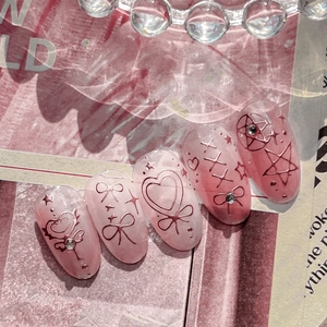 Pink heart press-on nails with magical star patterns and sparkling crystal rhinestones