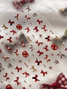 Detail of cute plaid horse nail art stickers with brown patterns and apple accents