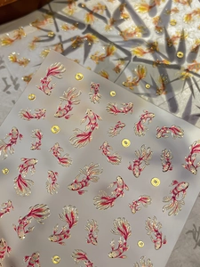 Detailed view of Koi fish nail art stickers with golden accents and Chinese style design