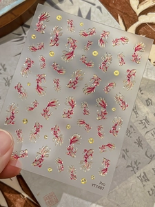 Macro detail of YT7487 nail art stickers with gold koi fish designs on clear backing