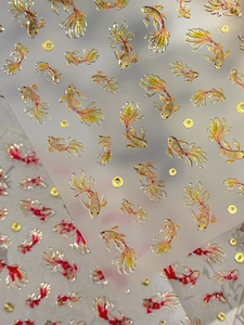 Macro detail of 3D embossed gold koi fish nail stickers with traditional Chinese motifs
