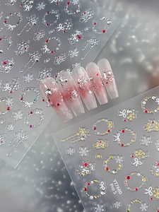 Detail of 3D embossed Christmas nail stickers with silver snowflakes and holiday motifs
