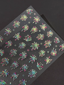 Macro view of holographic firework and star nail stickers with laser glitter finish