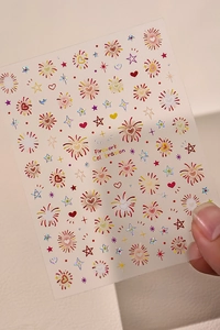 Detail of laser fireworks and heart nail stickers with a holographic chrome finish