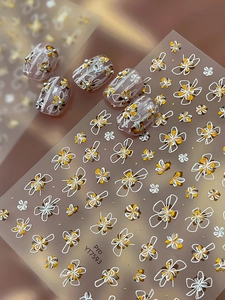 Détail des stickers ongles dorés YT7593 sur des faux ongles violets œil de chat