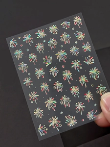 Close-up of holographic firework nail stickers showing rainbow reflections on transparent film