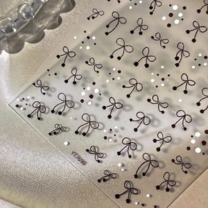 5D embossed nail art stickers featuring elegant black bows and dots on pearl background