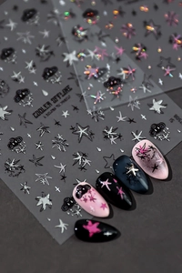 Macro shot of 5D embossed nail stickers with stars, clouds and cool graffiti lettering