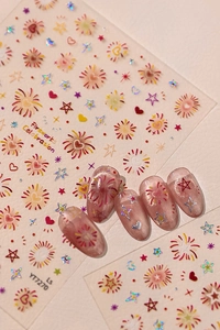 Detail showing fireworks and star nail stickers applied on pink pearlescent false nails