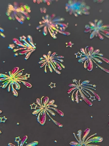Macro view of holographic 3D laser firework and star nail stickers with embossed texture
