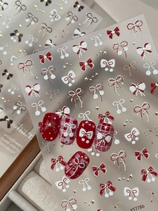 5D embossed nail stickers featuring red bows, gold stars, and pearls for winter manicure
