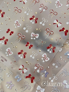 Macro view of YT7786 5D embossed nail stickers featuring red and white bow designs