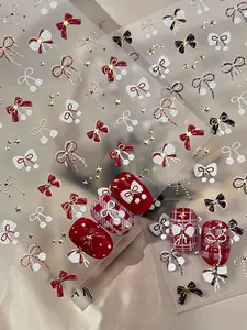 3D relief nail stickers featuring red bows and star designs for winter manicure