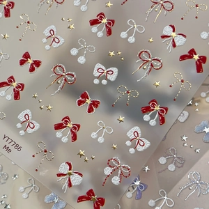 3D gold-stamped bow nail stickers with pearls and stars for festive winter manicure
