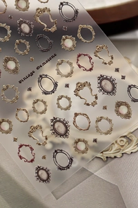Macro view of vintage 3D embossed nail stickers featuring golden frames and gemstone designs