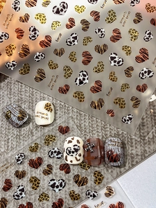 Detailed animal print nail stickers featuring leopard and heart patterns with love motifs