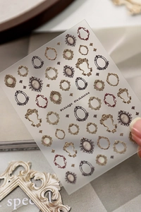 Macro detail of vintage Baroque photo frame nail art stickers with gold embossed textures
