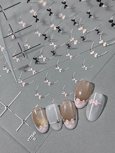 Detailed relief bow nail art stickers featuring pink and black cross ribbon designs