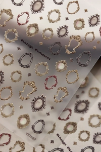 Macro detail of YT7607 3D embossed vintage frame and gemstone nail art stickers