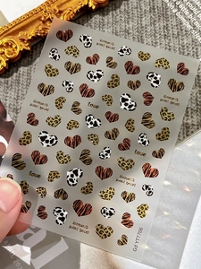 Detail of Gd YT7706 nail stickers with leopard and cow print hearts on vintage background
