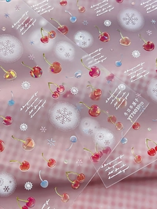 Detailed macro view of cherry and snowflake nail stickers with YT7603Pro pattern designs