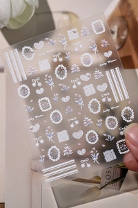 Detailed relief nail stickers featuring white flowers, pearls and Lucky Winter motifs