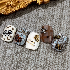 Leopard print heart press-on nails with metal cross charms and luxury checkered patterns