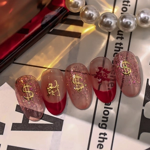 Red and pink gradient press-on nails with golden Chinese characters and dollar sign symbols