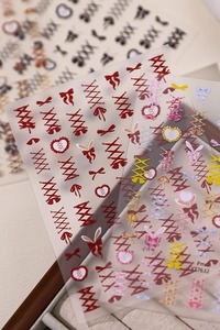 Detail view of ballet bow nail stickers with sweet lolita patterns and heart designs
