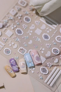 Detail showing 3D embossed nail stickers with delicate floral and pearl designs