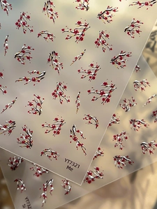 Detailed view of 5D red winter plum blossom nail art stickers with golden snow accents